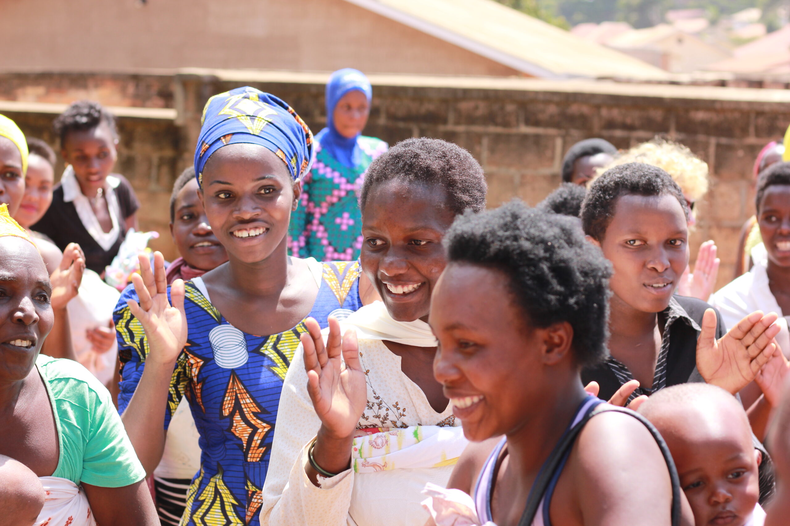 A group of women smiling and dancing