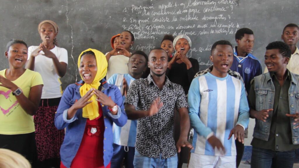 Children of liberty singing a song in class